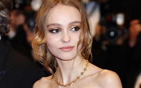 Lily Rose Depp poses topless and flashes her assets in a sheer top